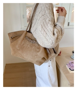 Detail of adjustable side buckle on brown frosted suede tote bag for women