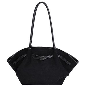 Detail of black matte tote bag featuring thin patent leather straps and silver metal buckle