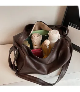 Interior view showing the large storage capacity of the dark brown shoulder bag