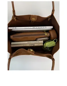 Interior view of brown tote bag showing large capacity and zipper inner organizer pouch