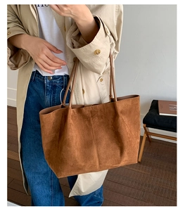 Brown matte suede tote bag shown on model highlighting the large capacity and minimalist design