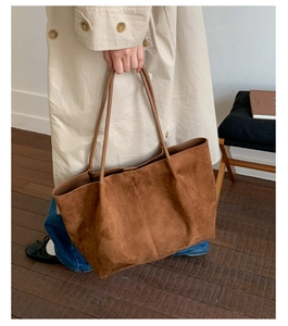 Detail view of large brown suede tote bag for women showing soft texture and spacious design