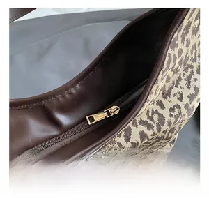 Macro shot of durable golden zipper and leopard print fabric on large tote bag