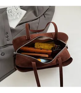 Top view of spacious brown suede pillow bag showing large interior capacity and zipper