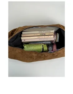 Interior view of large brown suede hobo bag showing spacious storage for daily essentials