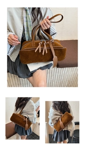 Detail of dark brown suede handbag featuring long leather fringe and dual zippers