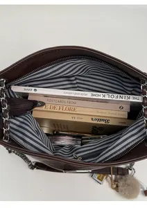 Top view of large brown leather tote with striped lining showing spacious interior storage