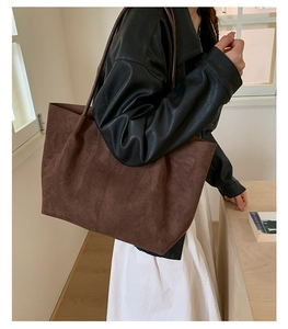 Side view of dark brown faux suede tote bag on shoulder for daily commute style