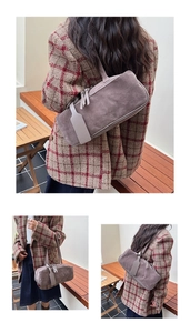 Detail of vintage suede shoulder bag with long tassel zipper and elegant leather tag