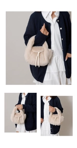 Close-up of soft plush white handbag with decorative ribbon and textured faux fur