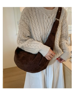 Detail view of large dark brown suede hobo bag with adjustable wide shoulder strap