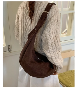 Detail of suede hobo bag showing deep brown texture and silver adjustable buckle