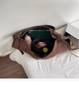 Macro shot showing the spacious interior of the brown suede tote bag with multiple compartments