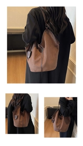 Detail showing the brown suede hobo bag worn over the shoulder on a black coat