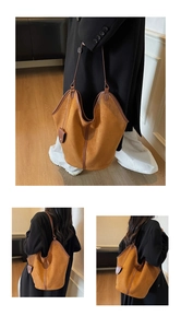 Detail view of large camel suede tote bag with brown leather trim and side accessory