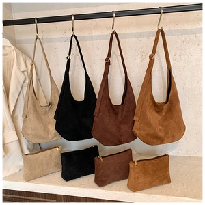 Detail of large hobo shoulder bags and matching zipper pouches in four earthy colors