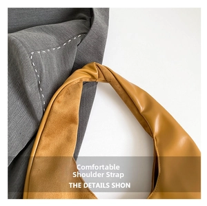 Detail of soft yellow faux leather shoulder strap with microsuede lining and stitching