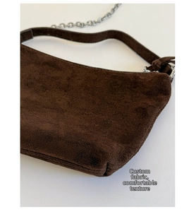 Detail view of dark brown frosted faux suede shoulder bag with silver metal chain strap