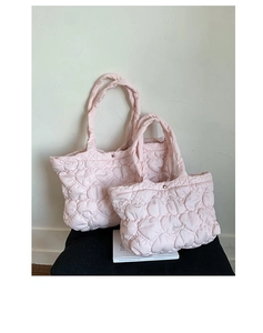 Close-up of pink quilted tote bags in two sizes with detailed heart pattern stitching