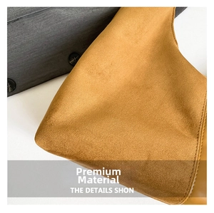 Close-up of premium brown suede leather texture and precision stitching on a tote bag