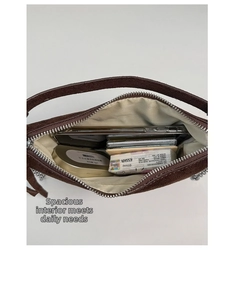 Interior view of brown suede crossbody bag showing capacity for phone and essentials