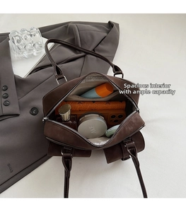 Interior view of brown suede handbag showing spacious storage for daily essentials