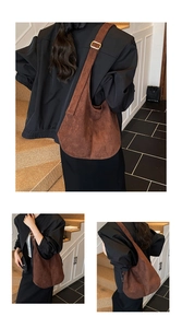 Detail of adjustable gold buckle on brown suede hobo tote bag with wide strap