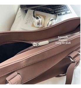 Détail du zip argenté fluide sur un sac cabas en cuir moka foncé pour le bureau