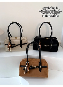 Detail of crossbody bags with wood bead charms and metallic buckle closure