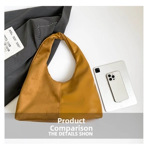 Detail view of the yellow-brown hobo bag showing mixed textures and knotted handle