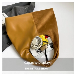 Spacious interior of brown color-block tote bag showing storage for umbrella and phone