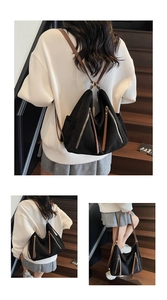 Detail of black matte tote with dual metal zippers and long leather tassels