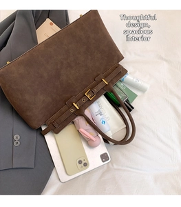 Detail showing high-capacity interior of brown suede tote bag with daily essentials