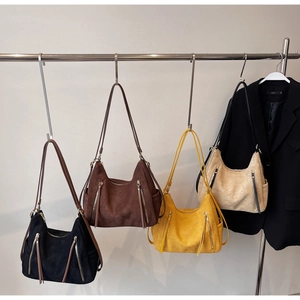 Showcase of four large suede tote bags in black, brown, yellow and beige colors