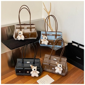 Detailed view of four colorful tote bags with bear charms on creative indoor steps