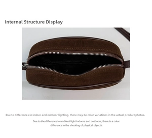 Interior view of brown suede bowling bag showing black lining and metal zipper