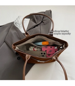 Top view of brown tote bag showing large internal capacity with a zipper pocket