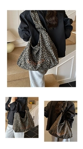 Close-up of leopard print canvas tote bag with orange embroidered letter detail