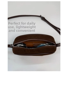 Top view of compact brown suede crossbody bag showing interior storage for essentials