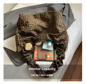Macro view of leopard print tote bag interior showing large capacity for tablet and phone