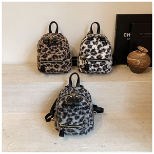 Detailed close-up of mini leopard print plush backpacks in three stylish colors