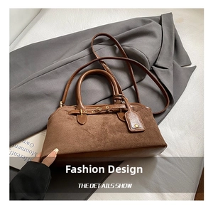 Close-up of brown suede and leather texture with belt buckle on a vintage tote bag
