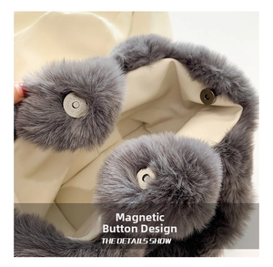 Detail of the magnetic buckle closure and beige fabric lining on the grey plush tote bag