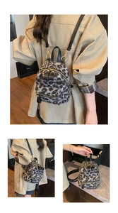 Detail showing plush leopard print backpack texture with premium gold metal zippers