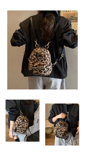 Macro view of leopard print plush backpack showing soft faux fur and gold metal hardware