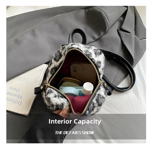 Detail view of mini leopard faux fur backpack interior with smartphone and cosmetics