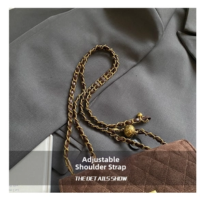 Detail showing the adjustable leather and metal chain strap on a brown quilted bag