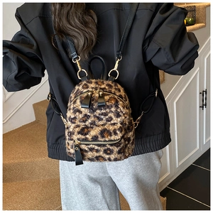 Detailed back view of a mini leopard print backpack featuring soft faux fur and gold hooks