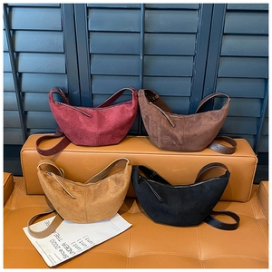 Detail view of retro suede crescent crossbody bags in burgundy, brown, camel and black colors