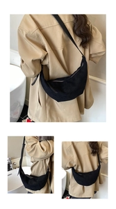 Detail of matte black suede croissant bag with shoulder strap and smooth zipper closure